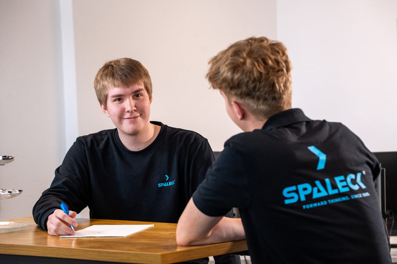 Two young men talking at SPALECK AUSBILDUNG.